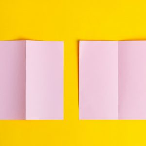 Bifold mock-up pink paper brochures on a yellow background